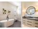 Elegant bathroom with freestanding tub and modern vanity at 24351 N 97Th Dr, Peoria, AZ 85383