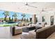Large covered patio with comfortable seating and ceiling fans, overlooking the pool at 24351 N 97Th Dr, Peoria, AZ 85383