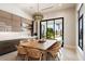 Breakfast nook with a large wooden table and access to the backyard at 24351 N 97Th Dr, Peoria, AZ 85383
