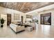 Modern living area with high ceilings, light floors, and a large chandelier at 24351 N 97Th Dr, Peoria, AZ 85383