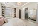 Bright bedroom with window seat and en-suite bathroom at 24351 N 97Th Dr, Peoria, AZ 85383