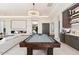 Relaxing game room includes a billiard table, wet bar, and comfortable seating at 24351 N 97Th Dr, Peoria, AZ 85383