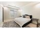 Bright bedroom with a plush bed, large window, and window shutters at 24351 N 97Th Dr, Peoria, AZ 85383