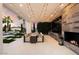 Modern outdoor kitchen with fireplace and dining area under string lights at 24351 N 97Th Dr, Peoria, AZ 85383