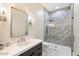 Spa-like bathroom with a walk-in shower, stylish vanity, and herringbone tile at 24351 N 97Th Dr, Peoria, AZ 85383