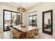 Bright dining room features a large table with seating for eight and views of the backyard pool at 24351 N 97Th Dr, Peoria, AZ 85383