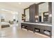 Double vanity bathroom with modern fixtures and a view into the bedroom at 24351 N 97Th Dr, Peoria, AZ 85383