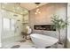 Bathroom with a freestanding tub, glass shower, and modern fixtures at 24351 N 97Th Dr, Peoria, AZ 85383