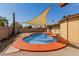 Inviting kidney-shaped pool with a shade sail at 3837 W Dailey St, Phoenix, AZ 85053