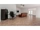 Living room with tile flooring, brown couch, and home office at 3837 W Dailey St, Phoenix, AZ 85053