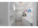 Laundry room with washer, dryer, and ample shelving at 3837 W Dailey St, Phoenix, AZ 85053