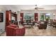 Living room with leather sofas, wood entertainment center, and red curtains at 20260 N 272Nd Ln, Buckeye, AZ 85396