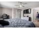 Primary bedroom with a large bed, home gym and TV at 42999 W Samuel Dr, Maricopa, AZ 85138