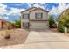 Two story home with beige exterior, brown shutters, and a two car garage at 42999 W Samuel Dr, Maricopa, AZ 85138