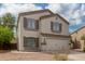 Two story home with beige exterior, brown shutters, and a two car garage at 42999 W Samuel Dr, Maricopa, AZ 85138