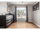 Bright bedroom with large window, dresser, and hardwood floors at 42999 W Samuel Dr, Maricopa, AZ 85138
