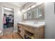 Bathroom with double vanity, large mirror and linen closet at 42999 W Samuel Dr, Maricopa, AZ 85138