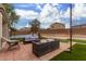 Backyard patio with seating area and artificial turf at 42999 W Samuel Dr, Maricopa, AZ 85138