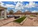 Backyard patio with seating area, artificial turf, and a pool at 42999 W Samuel Dr, Maricopa, AZ 85138