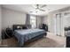 Primary bedroom with a large bed and ceiling fan at 42999 W Samuel Dr, Maricopa, AZ 85138