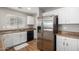 Modern kitchen with stainless steel refrigerator and white cabinets at 42999 W Samuel Dr, Maricopa, AZ 85138