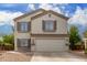 Two story home with beige exterior, brown shutters, and a two car garage at 42999 W Samuel Dr, Maricopa, AZ 85138