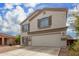 Two story home with beige exterior, brown shutters, and a two car garage at 42999 W Samuel Dr, Maricopa, AZ 85138