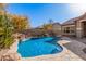 Inviting kidney shaped pool with a waterfall feature at 1364 E Grand Canyon Dr, Chandler, AZ 85249