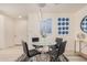 Modern dining area with glass table and four black chairs at 7300 E Earll Dr # 2021, Scottsdale, AZ 85251