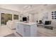 Modern kitchen with white cabinets, island, and stainless appliances at 7300 E Earll Dr # 2021, Scottsdale, AZ 85251