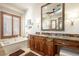 Spa-like bathroom with soaking tub, granite vanity, and large mirror at 36482 N Boulder View Dr, Scottsdale, AZ 85262