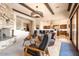 Open living room with kitchen views, stone fireplace, and comfortable seating at 36482 N Boulder View Dr, Scottsdale, AZ 85262