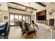 Spacious living room with stone fireplace, large windows, and access to patio at 36482 N Boulder View Dr, Scottsdale, AZ 85262