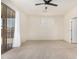 Bright bedroom with carpeting, ceiling fan, and sliding door access at 6599 E Casa De Leon Ln, Gold Canyon, AZ 85118