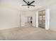 Bedroom with carpet, ceiling fan and access to living area at 6599 E Casa De Leon Ln, Gold Canyon, AZ 85118