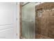 Tiled shower with glass door and mosaic accents at 6599 E Casa De Leon Ln, Gold Canyon, AZ 85118