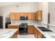Kitchen boasts granite countertops and ample wood cabinetry at 6599 E Casa De Leon Ln, Gold Canyon, AZ 85118