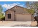 Single-story house with a two-car garage and desert landscaping at 6599 E Casa De Leon Ln, Gold Canyon, AZ 85118