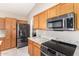 Modern kitchen with stainless steel appliances and wood cabinets at 6599 E Casa De Leon Ln, Gold Canyon, AZ 85118