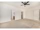 Spacious bedroom with ceiling fan and access to bathroom at 6599 E Casa De Leon Ln, Gold Canyon, AZ 85118