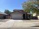 Two story home with tan exterior and a two car garage at 310 S 113Th Dr, Avondale, AZ 85323