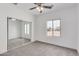 Well-lit bedroom with mirrored closet doors and neutral carpeting at 35075 N Palm Dr, San Tan Valley, AZ 85140