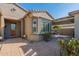 Inviting front entry with a covered patio and well-maintained landscaping at 20340 N Canyon Whisper Dr, Surprise, AZ 85387