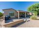 House exterior showcasing a covered patio and desert landscaping at 20340 N Canyon Whisper Dr, Surprise, AZ 85387