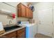 Laundry room with washer, dryer, cabinets, and a utility sink at 20340 N Canyon Whisper Dr, Surprise, AZ 85387