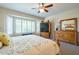 Main bedroom with a king-size bed and dresser at 20340 N Canyon Whisper Dr, Surprise, AZ 85387