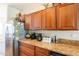 Kitchen features wood cabinets, granite countertops, and stainless steel appliances at 20340 N Canyon Whisper Dr, Surprise, AZ 85387