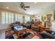 Spacious living room with leather furniture and a fireplace at 20340 N Canyon Whisper Dr, Surprise, AZ 85387