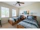 Bedroom with two twin beds, wood frame, and neutral decor at 20340 N Canyon Whisper Dr, Surprise, AZ 85387