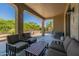 Covered patio with seating and a coffee table, ideal for relaxing at 20340 N Canyon Whisper Dr, Surprise, AZ 85387